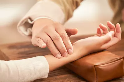 person getting their pulse checked