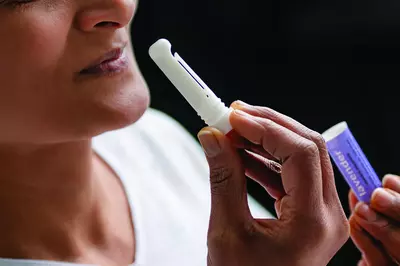 Patient holding aromatherapy stick.