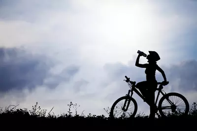 silhouette of a person riding a bike