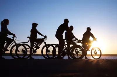 Group of people bicycling together
