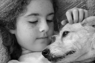 Girl cuddling a dog