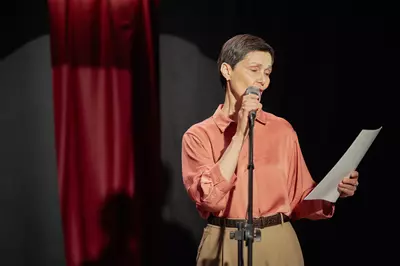 Person reading a script on stage