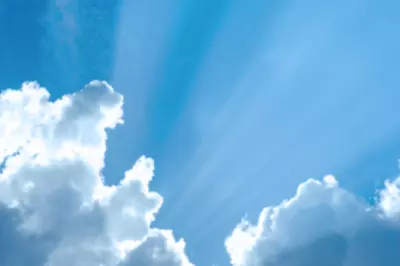 Sun peaking out from behind clouds