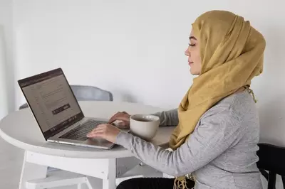 muslim woman looking at computer