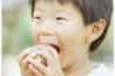 Young child biting into apple