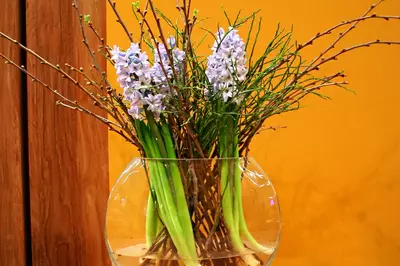 a vase of flowers on a wooden table