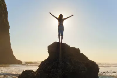 person standing on rock in bright sun