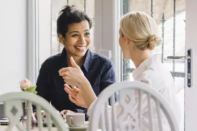 two women talking in a cafe