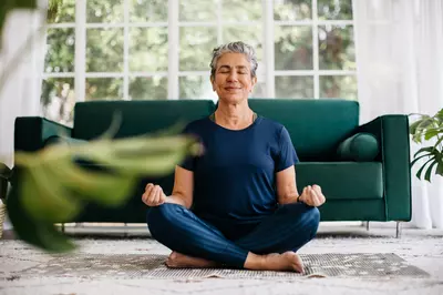 woman meditating in living room 