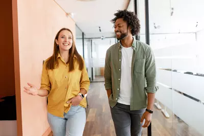 two people talking in a hallway