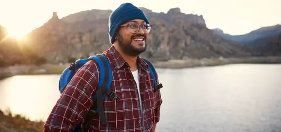 man in flannel hiking 