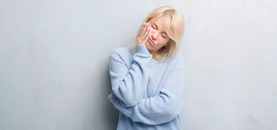 woman holding face
