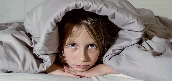 Child struggling to fall asleep.