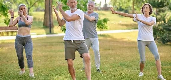 older people doing qigong in a park