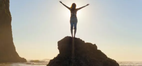 person standing on rock in bright sun