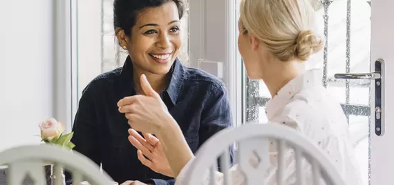 two women talking in a cafe