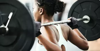 woman squatting with a barbell