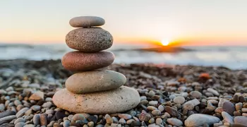 stacked rocks in front of sunset