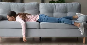 tired woman face down on a couch