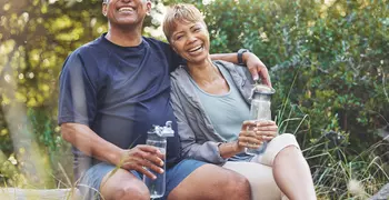 elderly couple smiling in a park