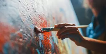 artist working on an oil painting