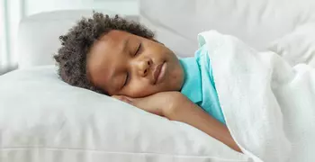 boy sleeping in bed 