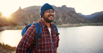 man in flannel hiking 
