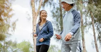 woman and grandfather walking in the park