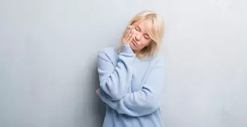 woman holding face