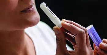 Patient holding aromatherapy stick.