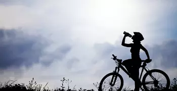 silhouette of a person riding a bike