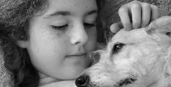 Girl cuddling a dog