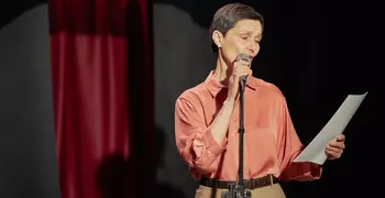 Person reading a script on stage