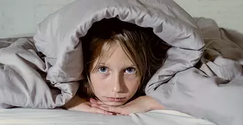 Child struggling to fall asleep.