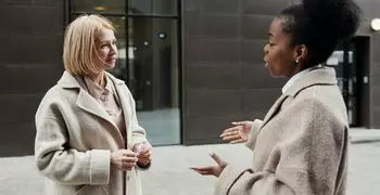 white woman listening to a Black woman