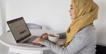 muslim woman looking at computer