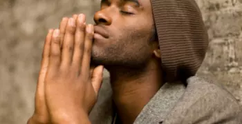 man with hands in prayer