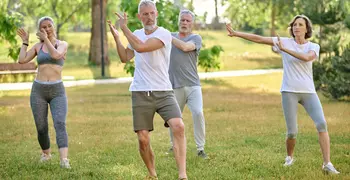 older people doing qigong in a park