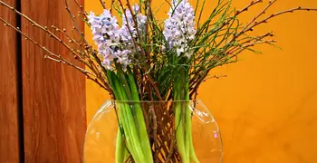 a vase of flowers on a wooden table