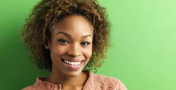 happy woman in front of green background