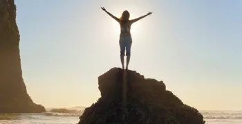 person standing on rock in bright sun