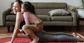 Family practicing yoga together.