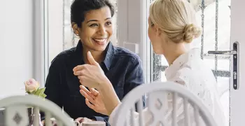 two women talking in a cafe