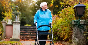 elderly woman walking in a park