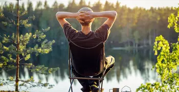 person relaxing by a lake 