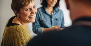 woman talking to two friends