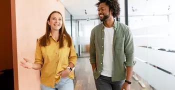 two people talking in a hallway