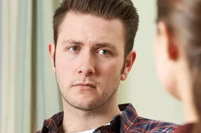 depressed man listening to a counselor