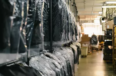 rows of suits in a dry cleaner