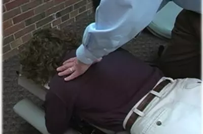 Chiropractor's hands on a female patient's back